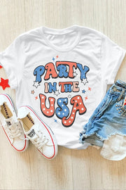 White t-shirt with retro "Party in the USA" graphic in red, white, and blue stars and lettering.