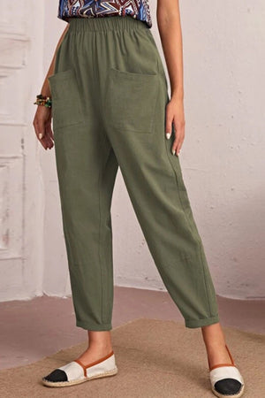 Relaxed linen tapered trousers in matcha green with elastic waist and large front pockets.