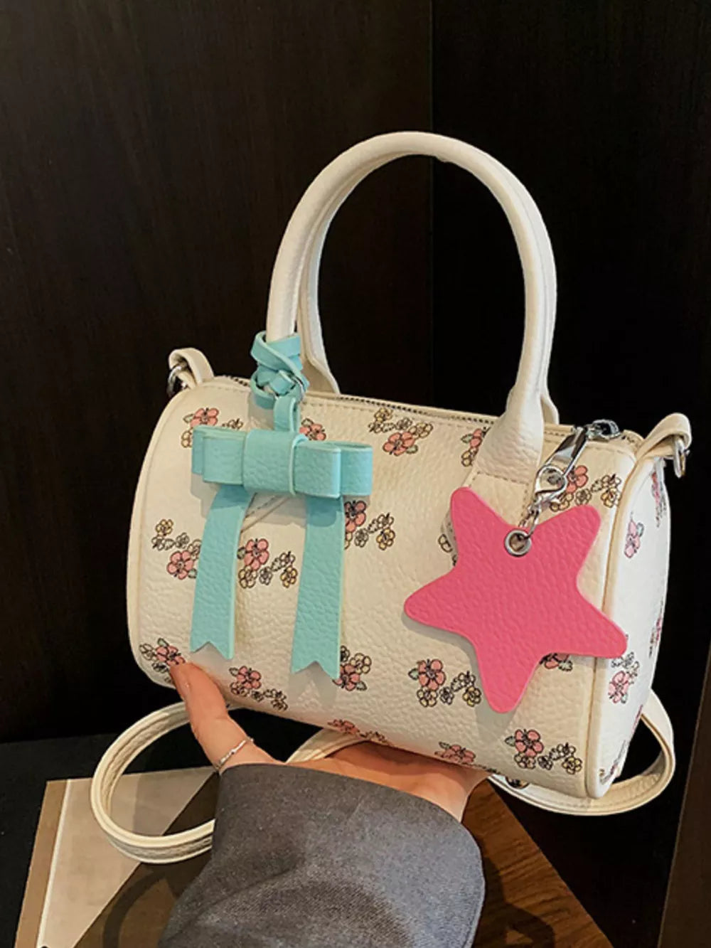 Charming floral barrel crossbody bag with blue bow and pink star charm