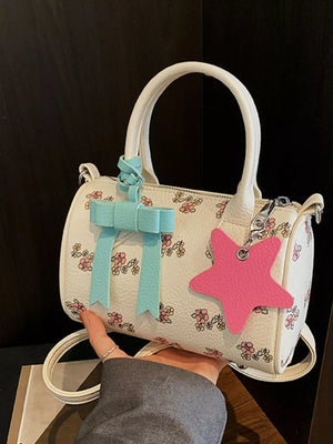 Charming floral barrel crossbody bag with blue bow and pink star charm