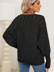 Black openwork dolman sweater with diamond pattern detail.