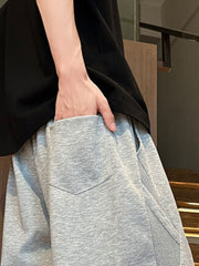 Men's light gray drawstring shorts with a back pocket detail.