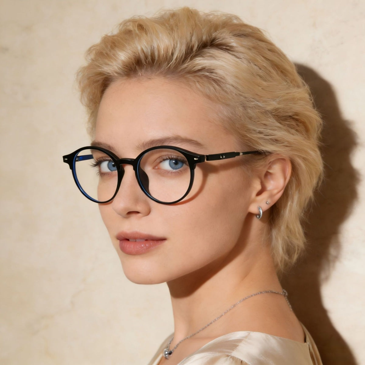 Black acetate round frame eyeglasses with clear lenses on a woman.