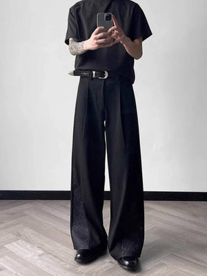 Men's black relaxed fit wide leg trousers with subtle embossed pattern detail on the side.