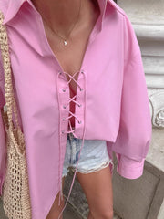 Pink cotton lace-up front relaxed fit shirt with a collared neckline and long sleeves.