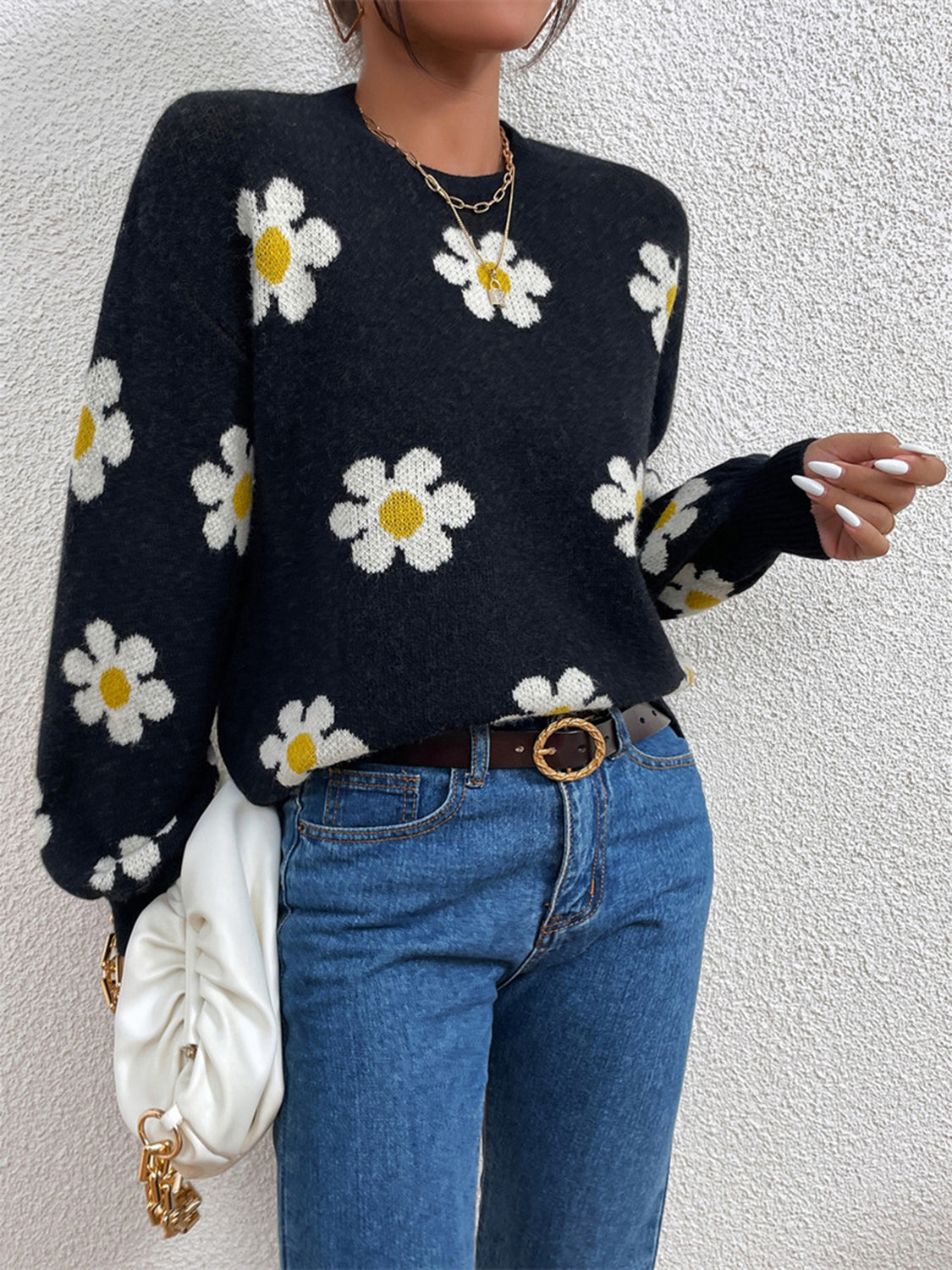 Black daisy print knit sweater with puff sleeves and crew neck.