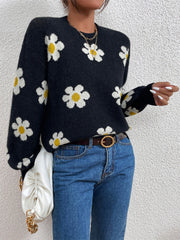 Black daisy print knit sweater with puff sleeves and crew neck.