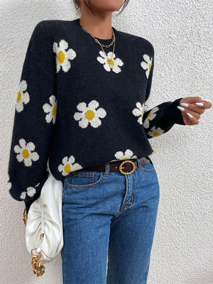Black daisy print knit sweater with puff sleeves and crew neck.