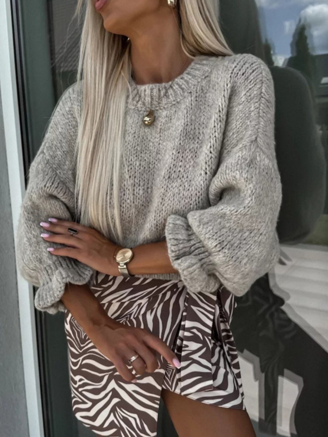 Voluminous sleeve knit sweater in heather grey acrylic with ruffled cuffs.