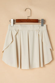 Beige ruffled skort with elastic waist and tie detail