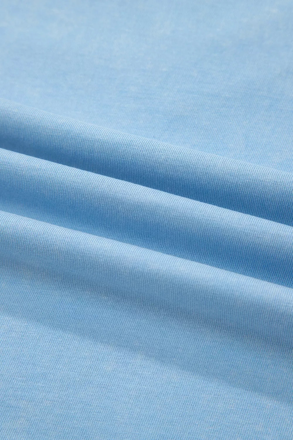 Light blue cotton relaxed V-neck top and skort ensemble fabric detail