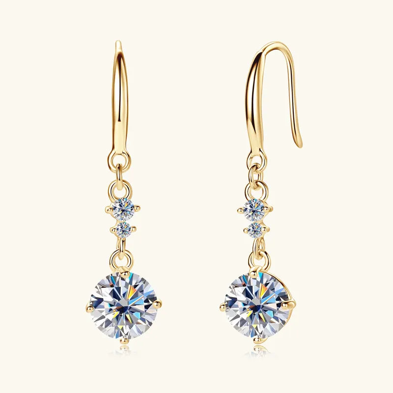 Gold celestial drop pendant earrings with clear cubic zirconia accents.