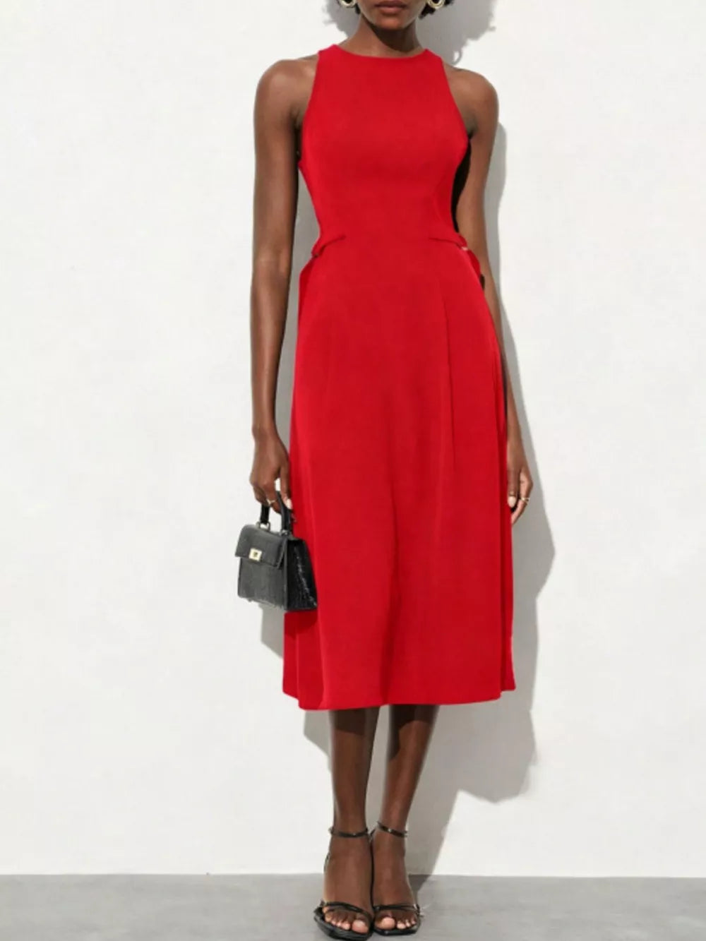 Red A-line midi dress with high neckline, sleeveless, defined waist, and pockets.
