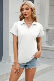 White textured polo top with cuffed short sleeves and a v-neck.