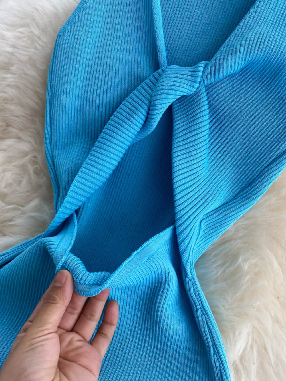 Light blue ribbed knit midi dress with knot-back detail and cutout.