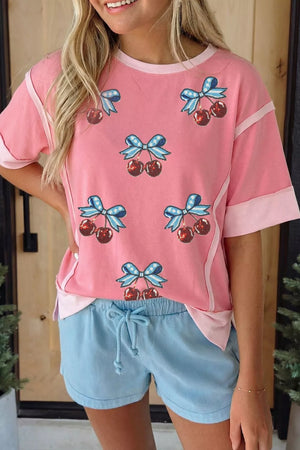 Pink polyester t-shirt with sequin cherry and bow graphic, contrast trim, short sleeves.