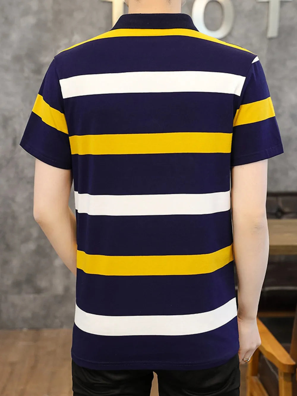 Navy blue cotton polo shirt with horizontal yellow and white stripes, short sleeves.