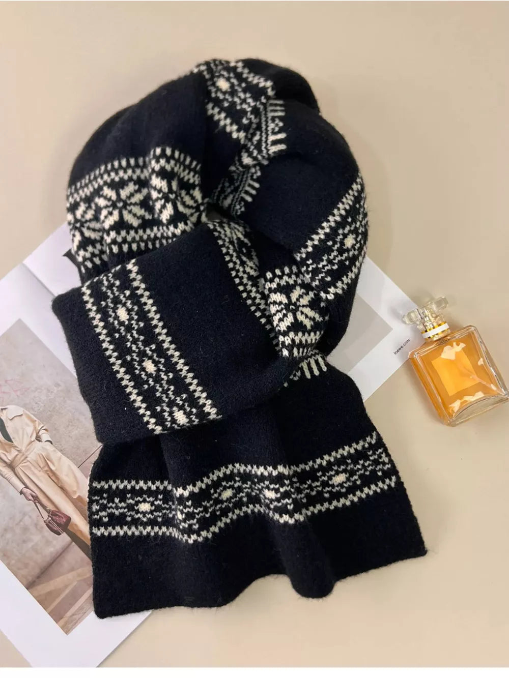 Black wool blend scarf with white snowflake pattern, cozy winter accessory.