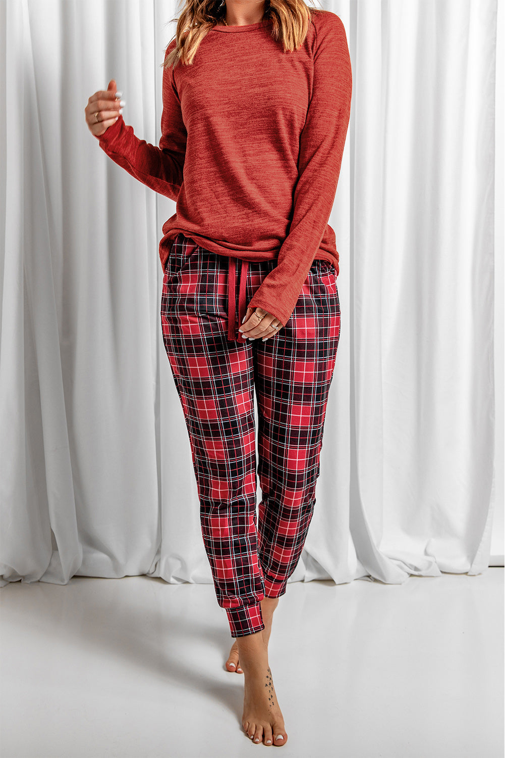 Cozy red plaid joggers with drawstring waist and matching long sleeve top.