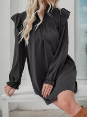 Dark gray ruffled notched sleeve dress with cinched cuffs and a gathered bodice.