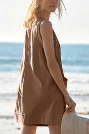 Brown linen relaxed fit romper with pockets, sleeveless, v-neck, casual beach style.