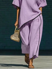 Purple half sleeve two-piece set with contrast trim and wide leg pants.
