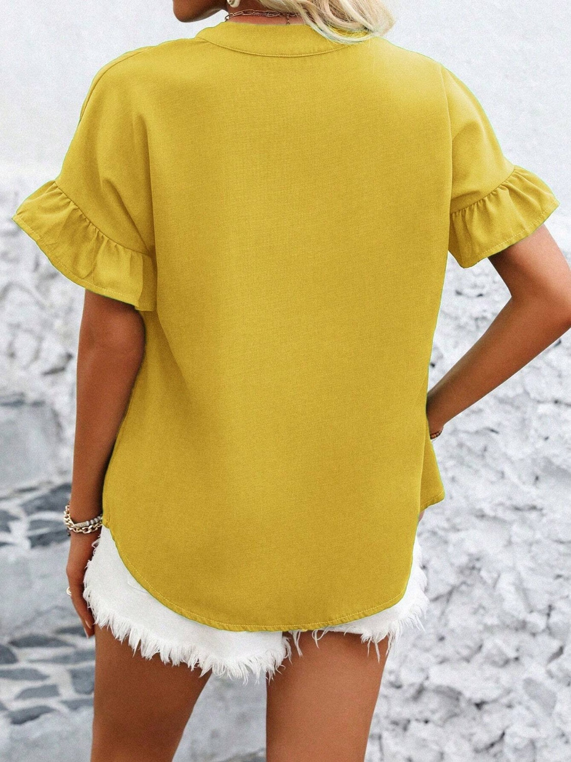 Yellow ruffled sleeve blouse with gathered yoke detail.