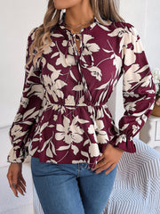 Burgundy floral peplum blouse with ruffled neck and tie detail