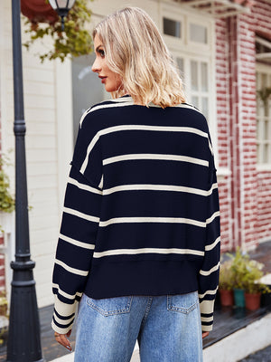 Navy and cream striped knit sweater with a polo neckline and long sleeves.