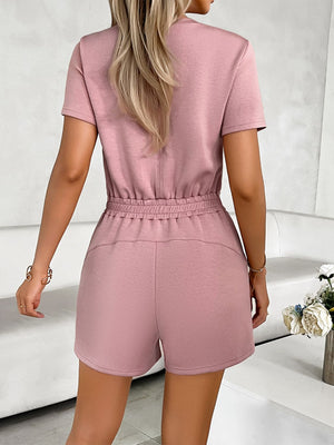Dusty pink t-shirt romper with drawstring waist and short shorts.