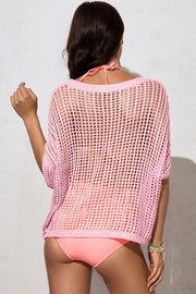Blush pink open-knit acrylic slouchy shoulder cover-up with short sleeves.