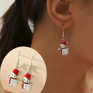 Festive snowman charm drop earrings with red hats and scarves, featuring crystal details.