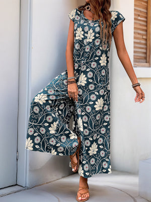 Botanical print culotte jumpsuit in dark green with short sleeves and wide legs.