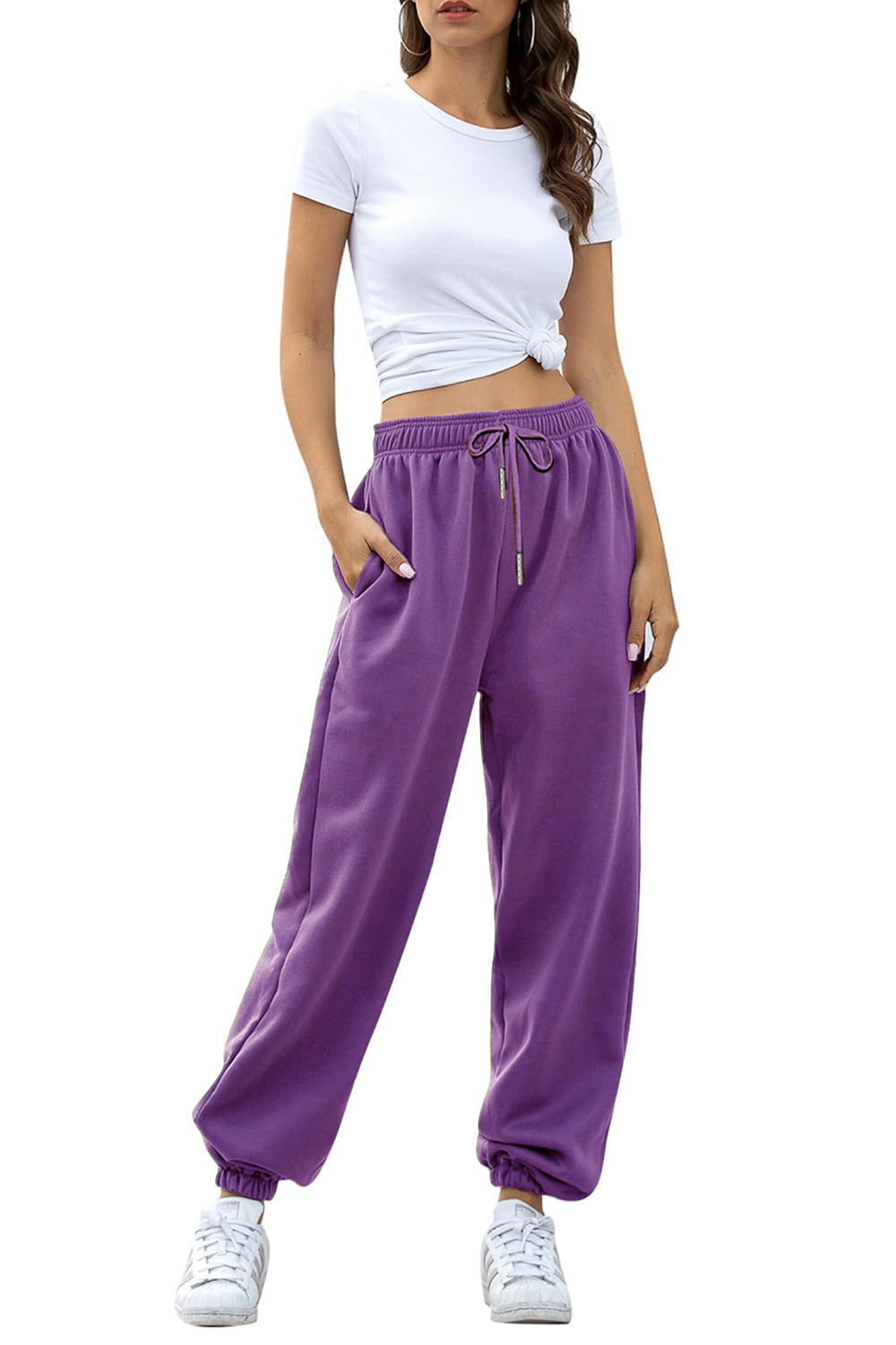Purple slouchy sweatpants with gathered cuffs and drawstring waist.
