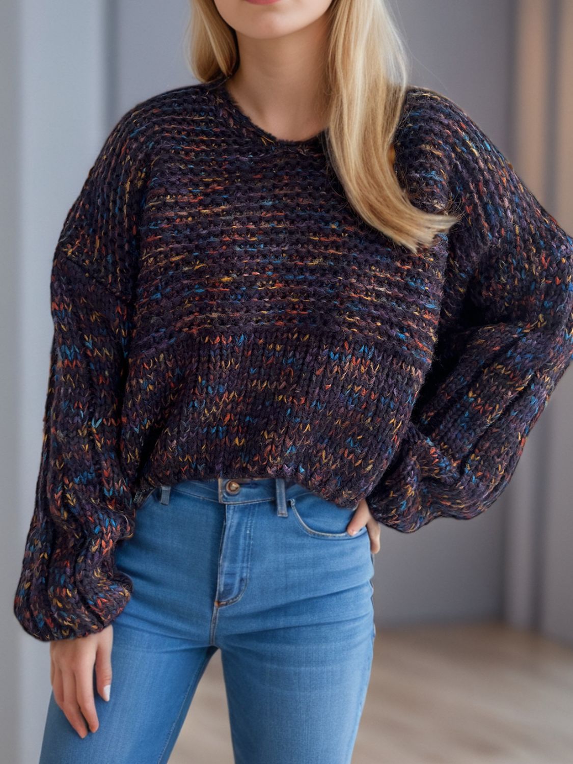 Textured knit sweater with balloon sleeves in a dark multicolor flecked yarn.