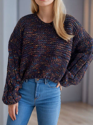 Textured knit sweater with balloon sleeves in a dark multicolor flecked yarn.