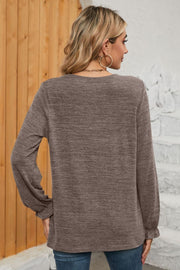 Mocha knit top with ruffled cuffs and long sleeves, back view.