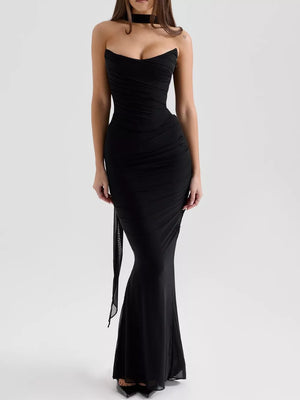 Black sweetheart ruched tube top maxi dress with sheer overlay and tie detail.