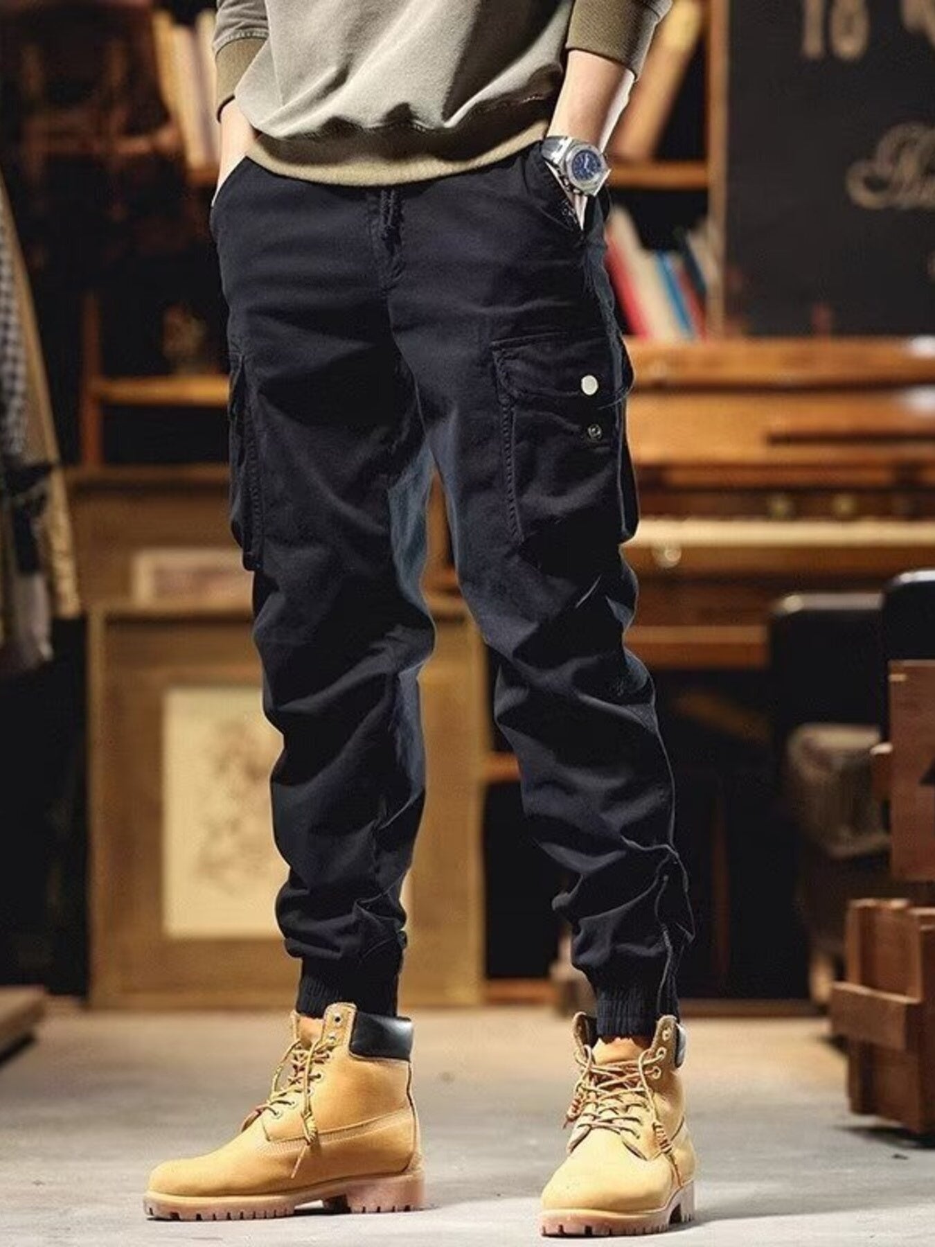 Men's black cargo joggers with drawstring and cuffed ankles.