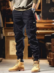 Men's black cargo joggers with drawstring and cuffed ankles.