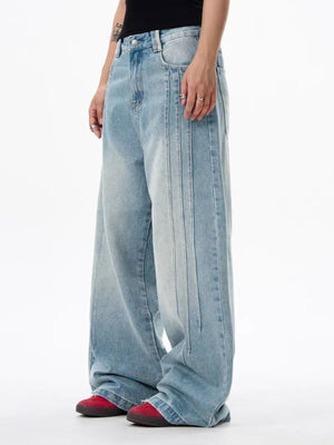 Men's light wash wide leg denim jeans with vertical seam details