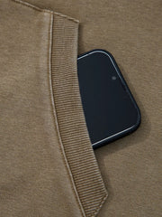 Mineral wash coffee brown hoodie with a phone in the pocket and ribbed trim detail.