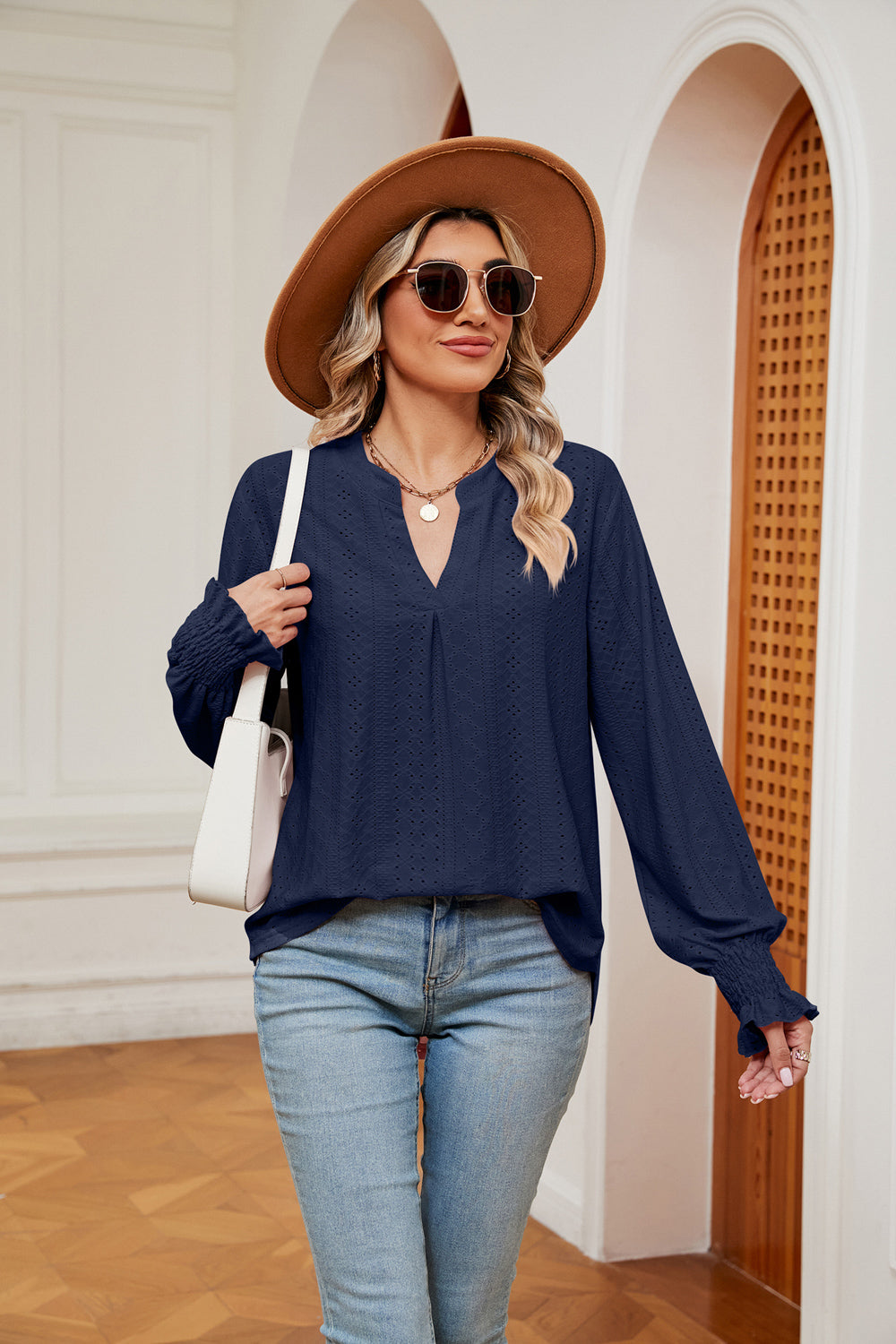 Navy eyelet detail blouse with V-neck and poet sleeves