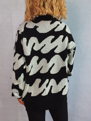 Graphic wave knit sweater in black and white with a crew neck and long sleeves.