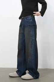Faded panel wide-leg denim trousers in medium wash with a relaxed fit.