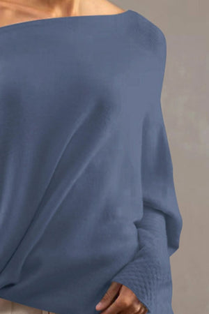 Dusty Blue off-shoulder knit sweater with textured cuffs and draped neckline.