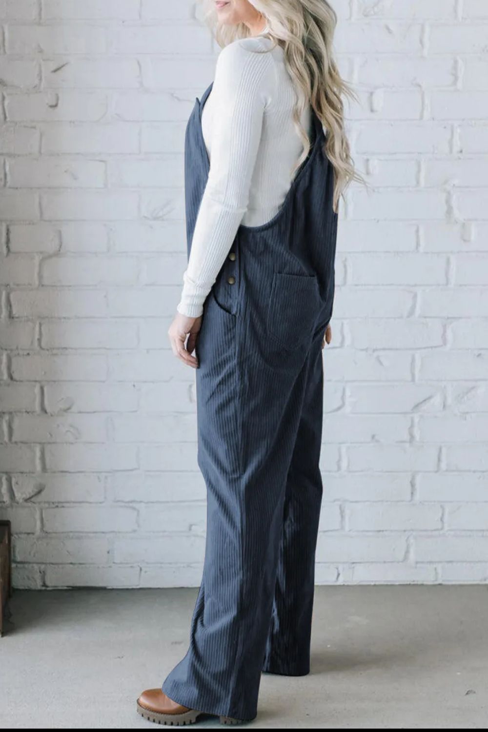 Peacock Blue corduroy wide-leg overalls with button details and pockets.
