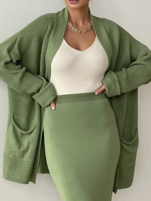 Ribbed knit co-ord set in Gum Leaf green, featuring a long cardigan with pockets and a fitted midi skirt.