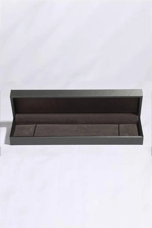 Sparkling Moissanite Silver Luxe Bracelet presentation box with dark grey exterior and brown velvet lining.