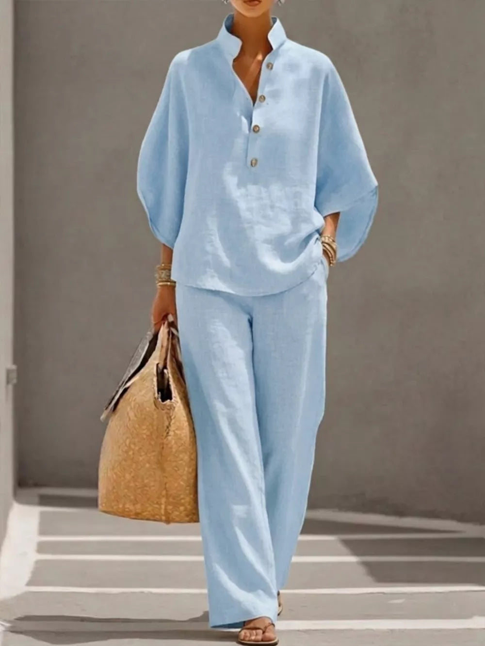 Sky blue button-down loungewear set with wide leg pants and a relaxed fit top.